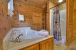 Upstairs Bathroom offers a large jetted tub, and shower stall 